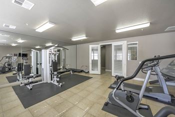 Workout room with strength training and cardio machines